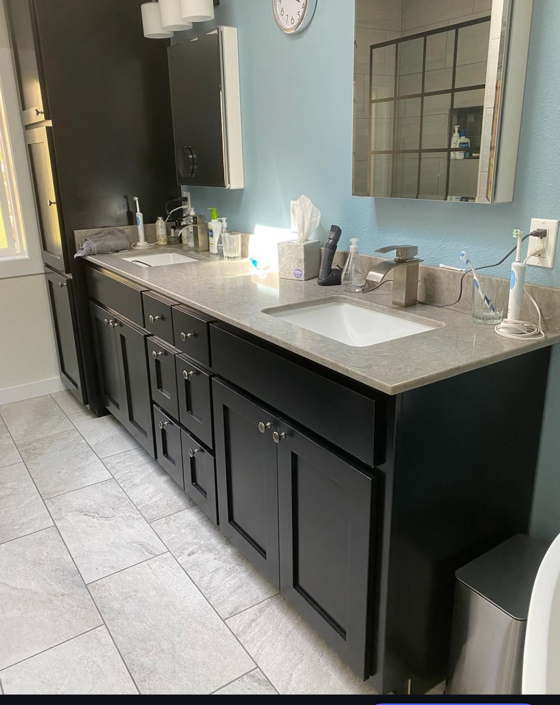 Spacious bathroom remodel featuring a modern dark-colored double vanity with light countertops and dual sinks, by Mills Builds Inc. serving Humboldt County, California.