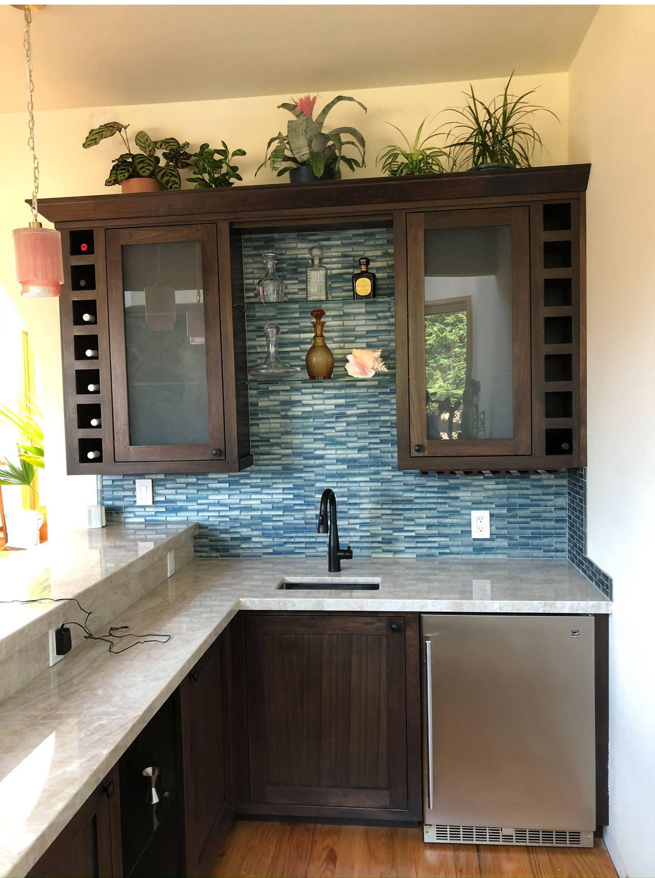 Custom-built wet bar area with dark wood cabinets, a sink, and wine storage, designed and installed by Mills Builds Inc. in Humboldt County, California.
