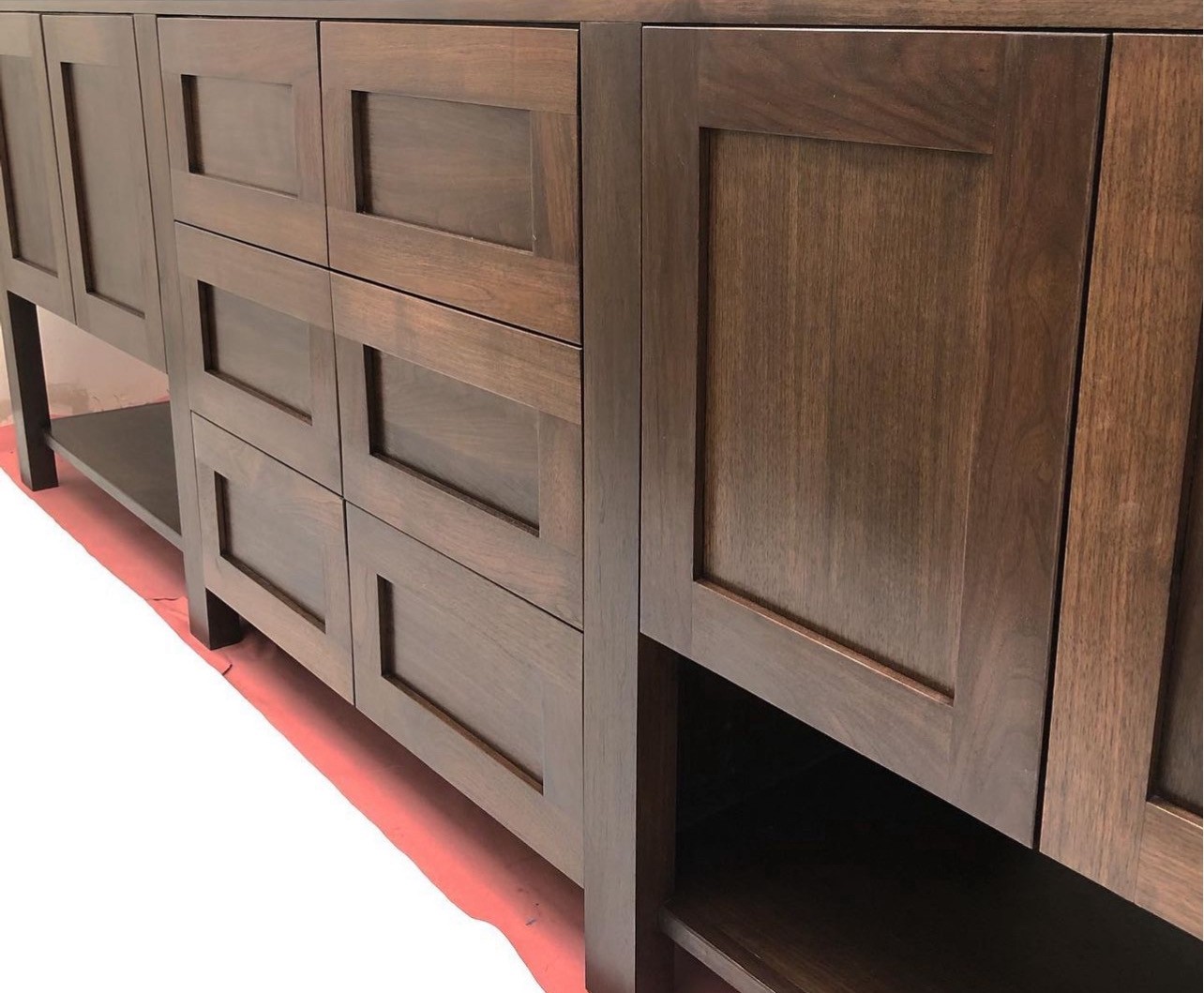 Close-up of a custom-designed wood bathroom cabinet with drawers and doors, crafted by Mills Builds Inc. in Humboldt County, California.
