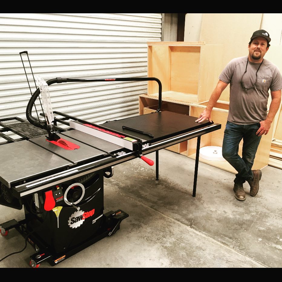 Photo of a skilled craftsman using a precision table saw in a woodworking shop.