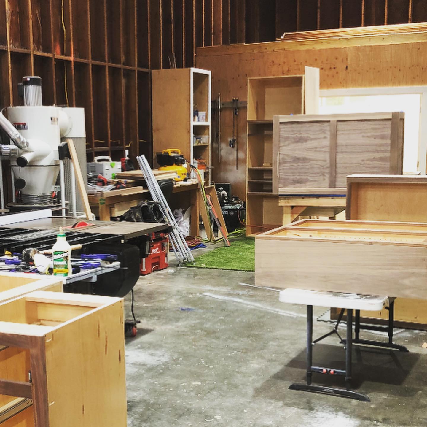 Cabinet building facility showing materials and equipment for custom cabinetry.