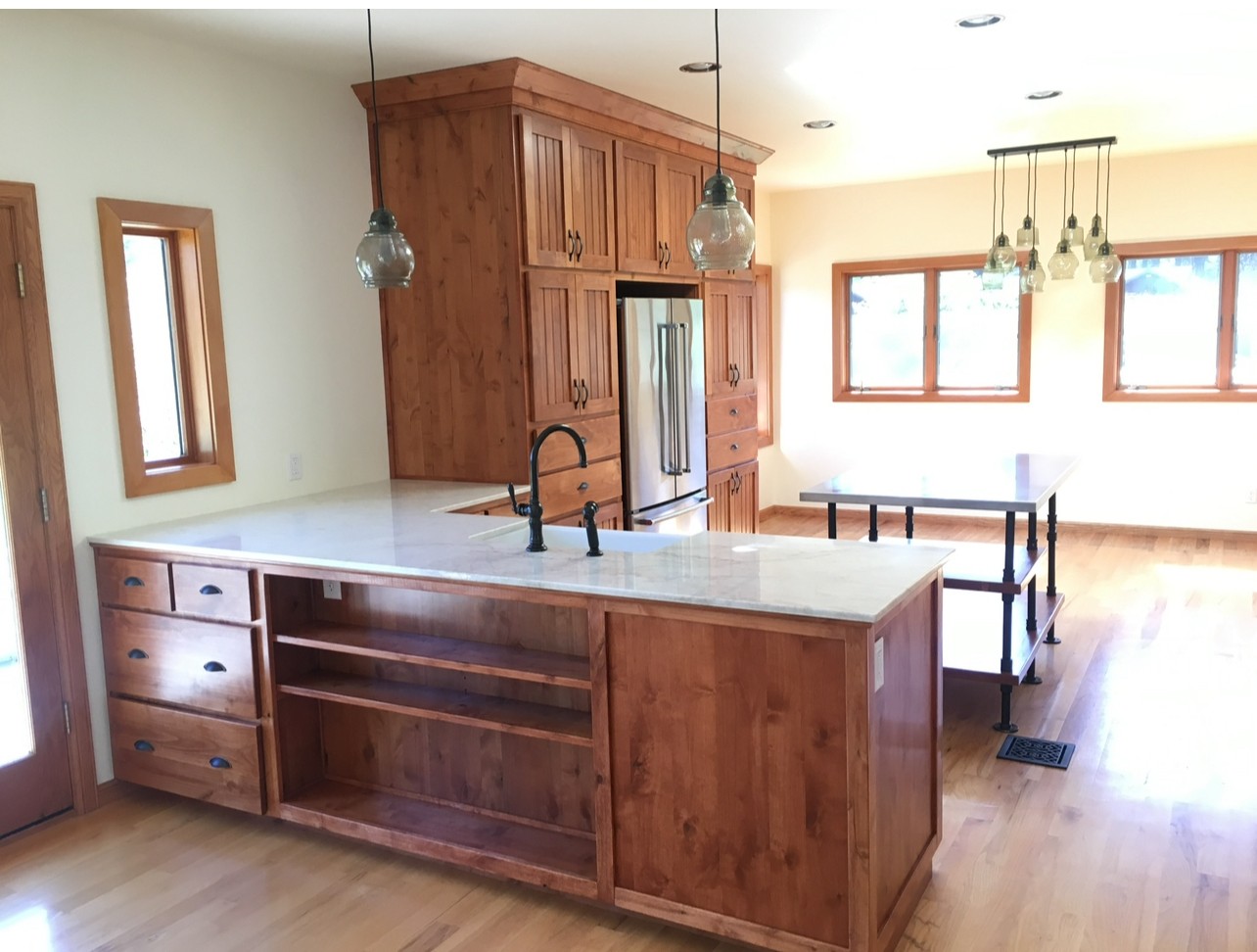 Custom dark wood kitchen cabinets installed by Mills Builds Inc.